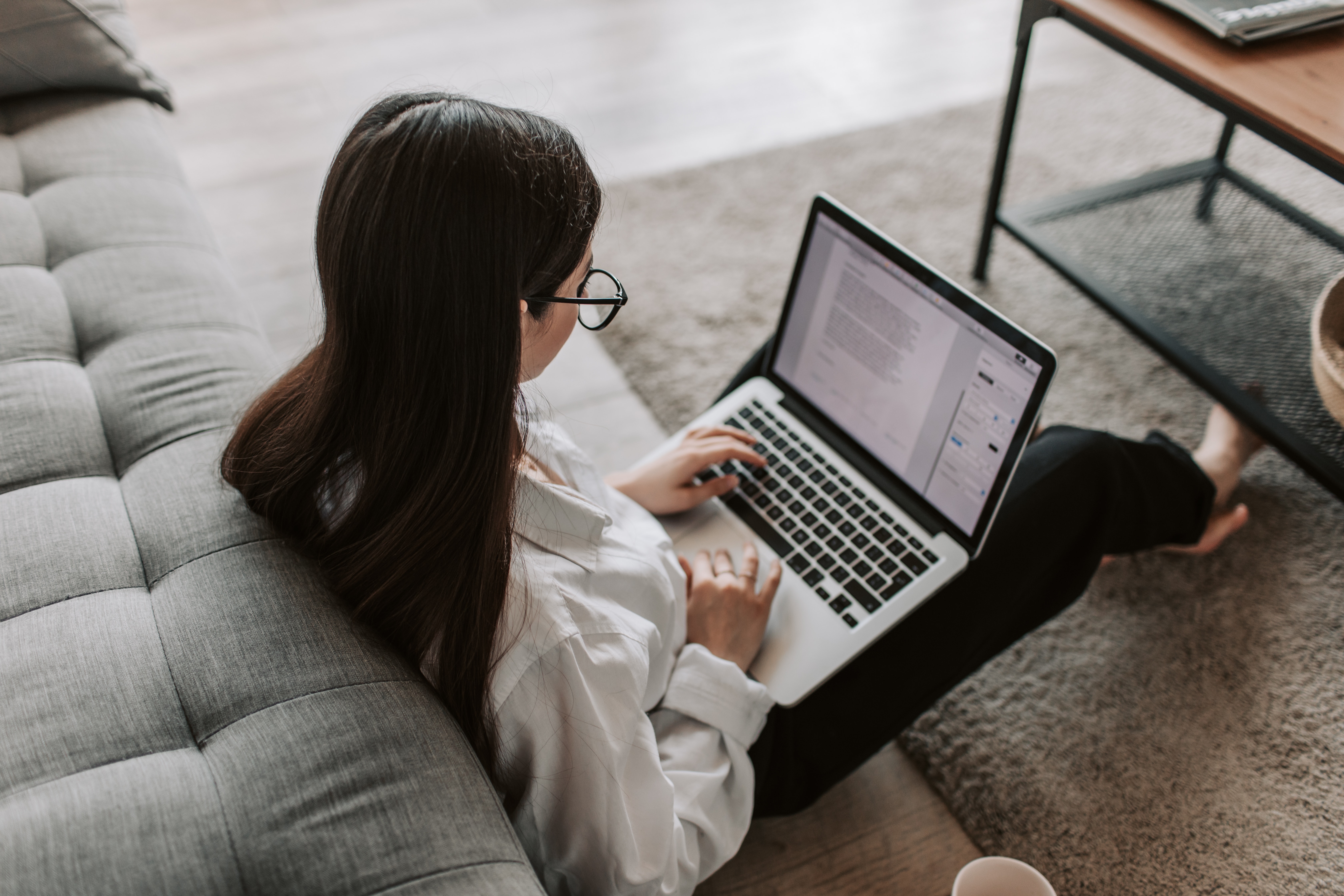 picture of a woman coding on her laptop.